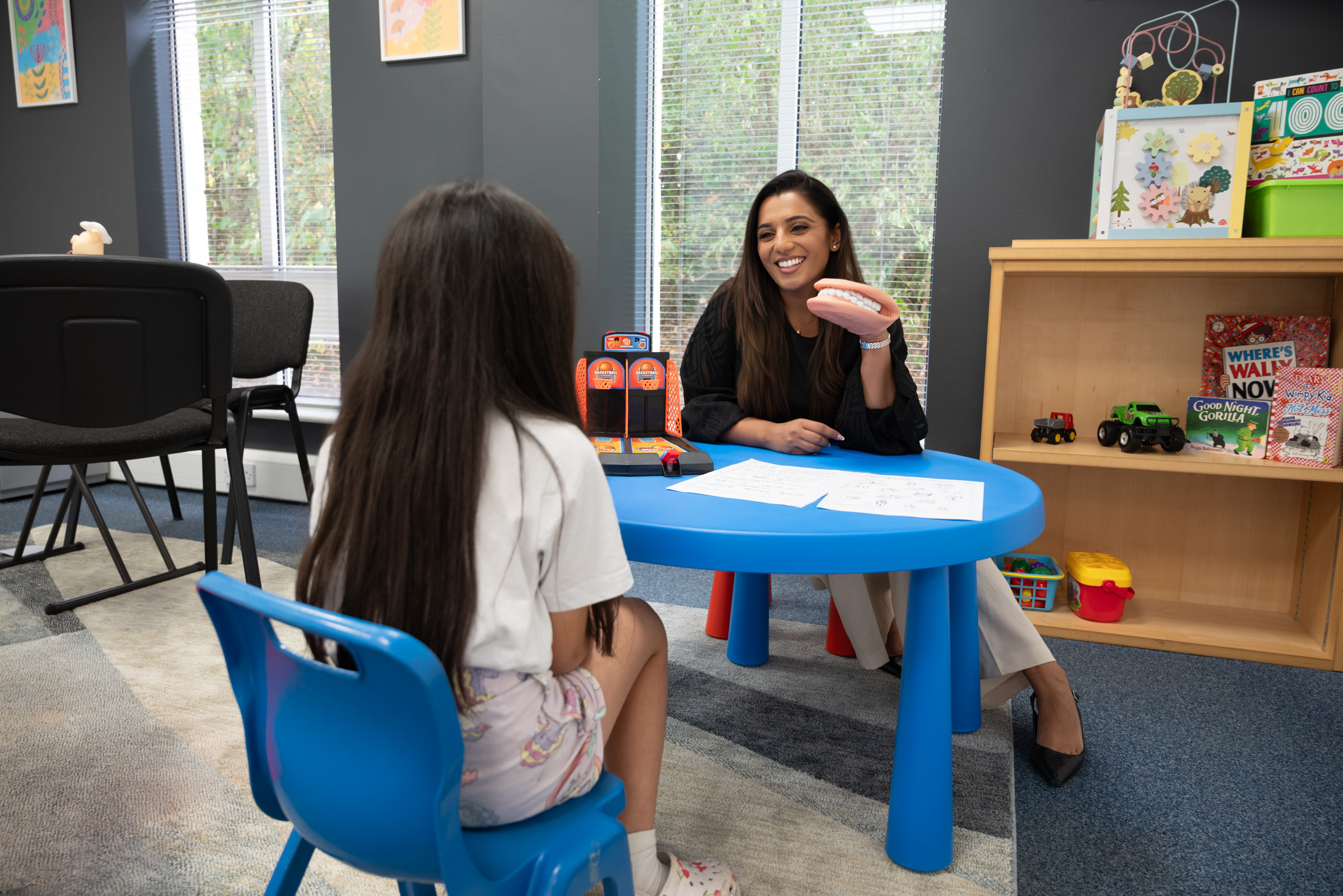Child happily playing with colourful blocks