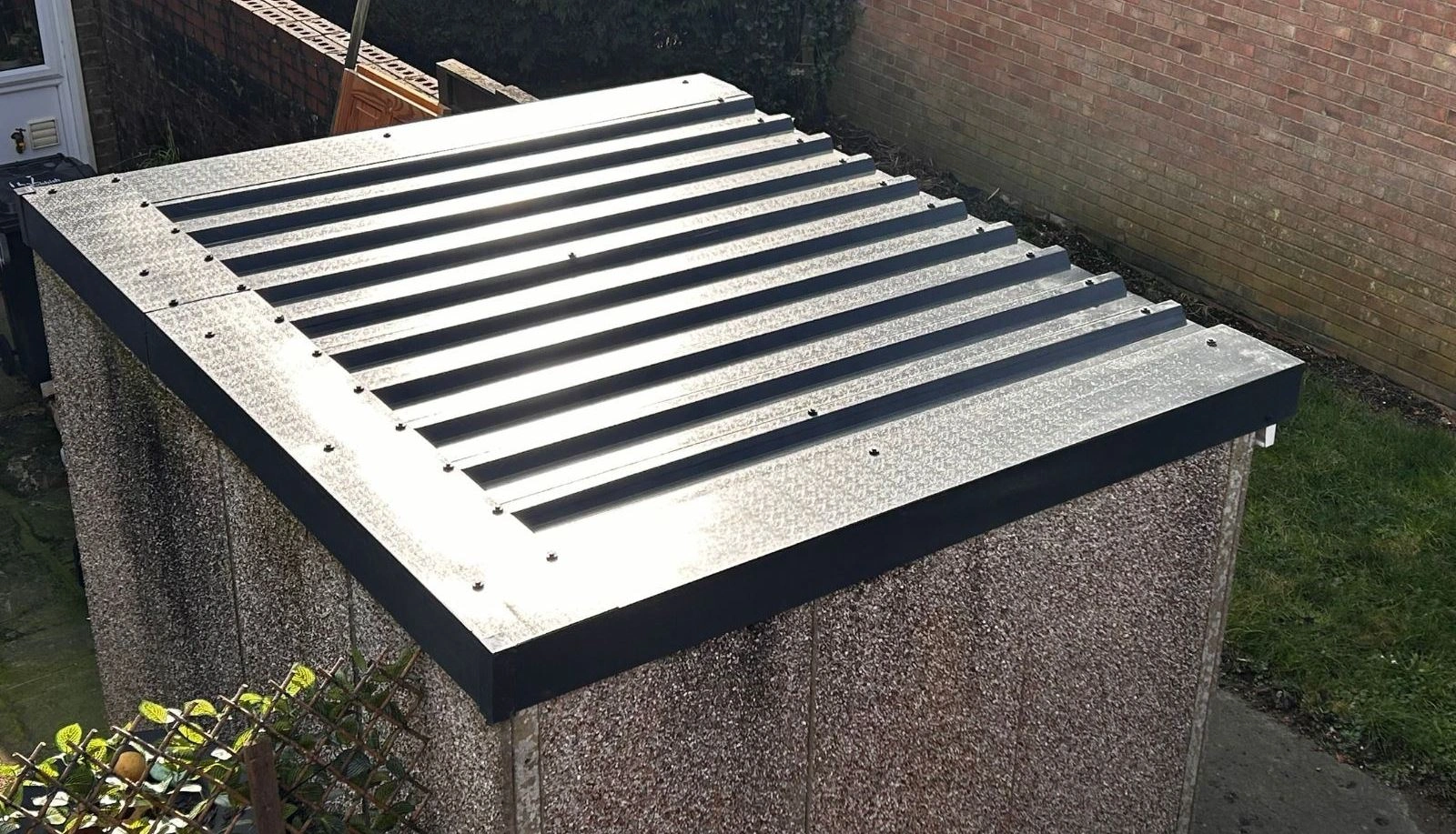 Newly replaced garage roof with clean corrugated metal sheets