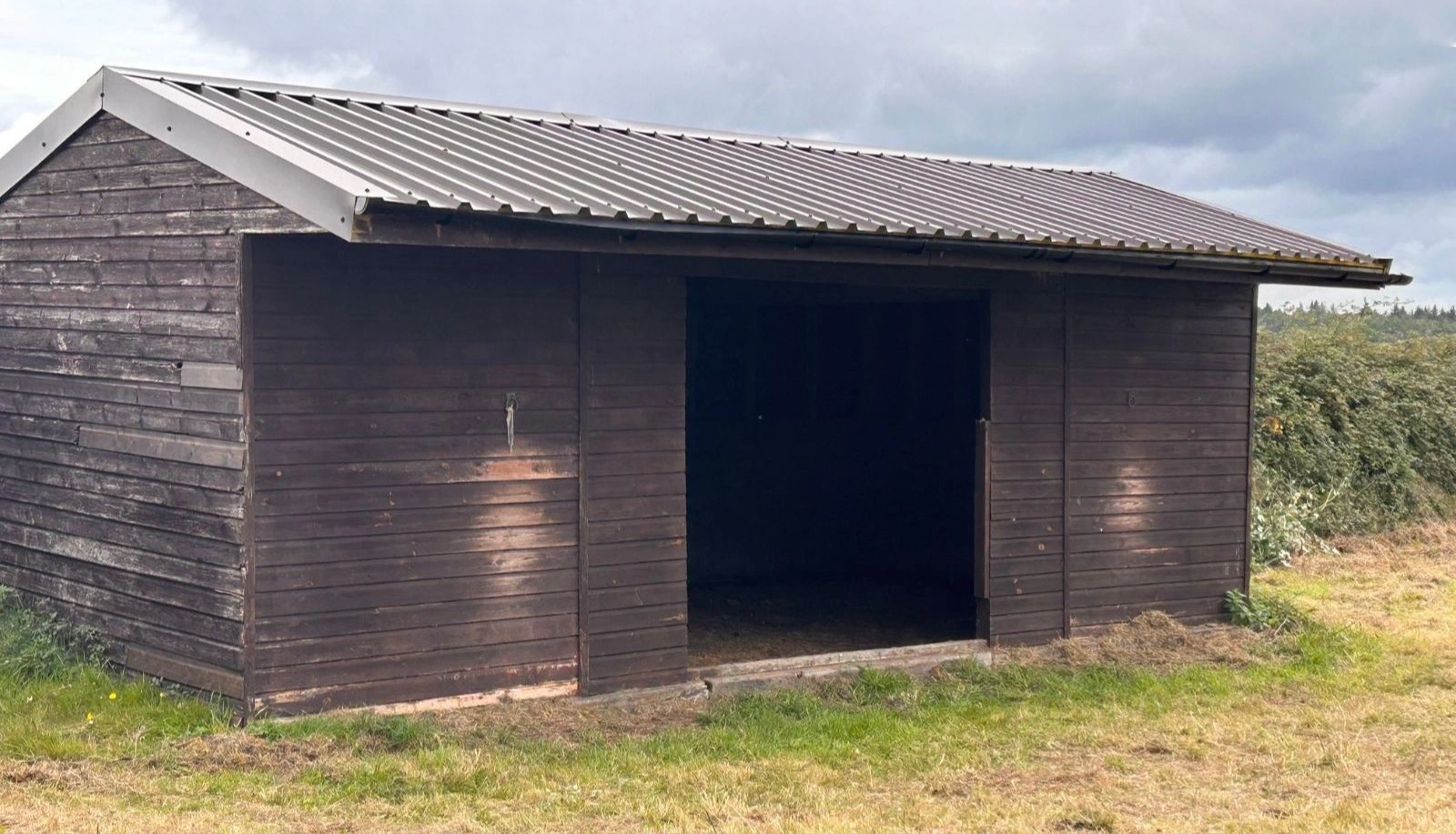 Refurbished timber shed with new corrugated metal roof panels